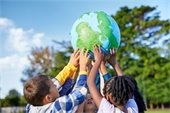Children holding up a globe