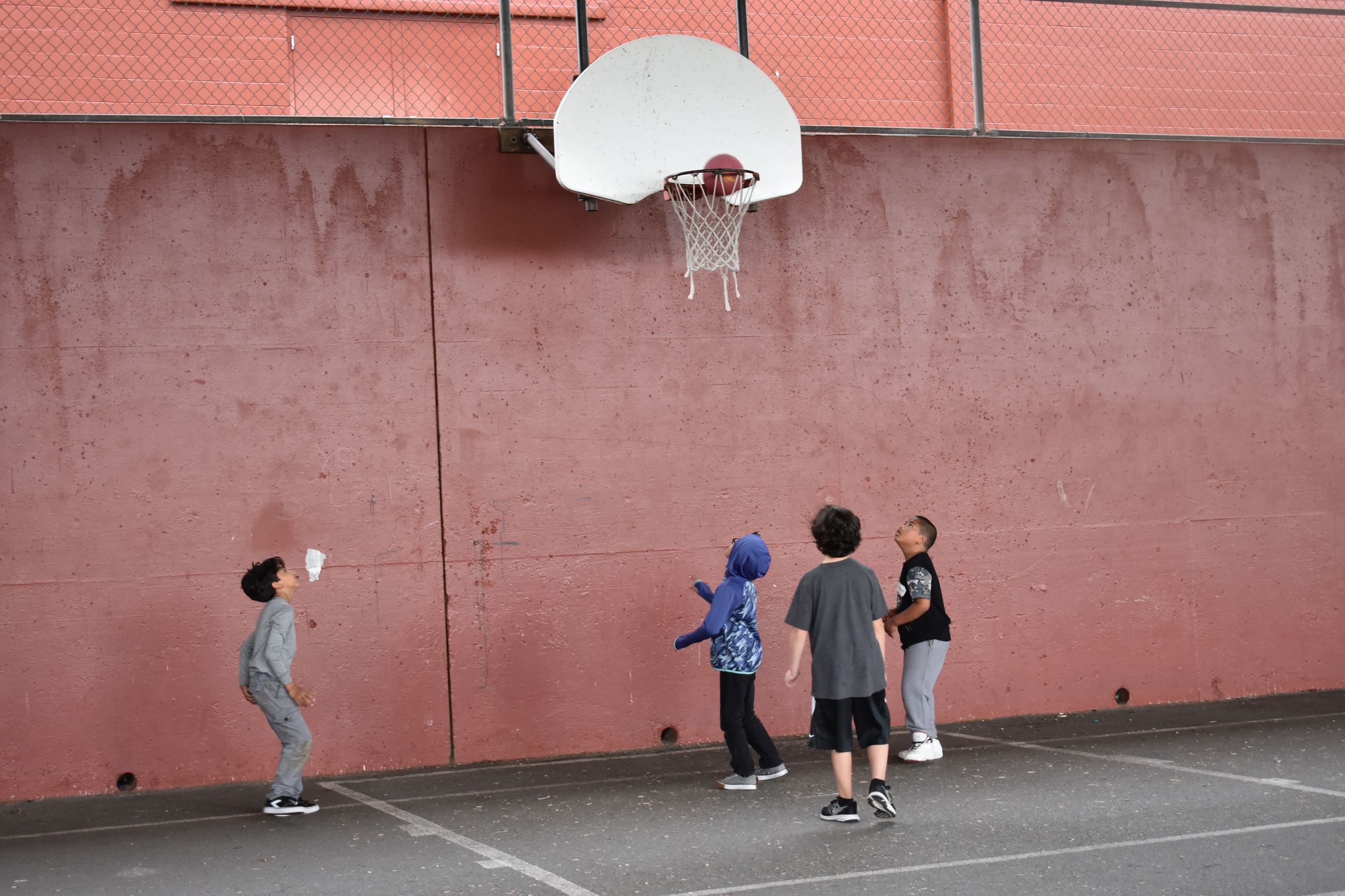 Four boys playing basketball