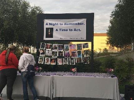 Guests light candles at vigil